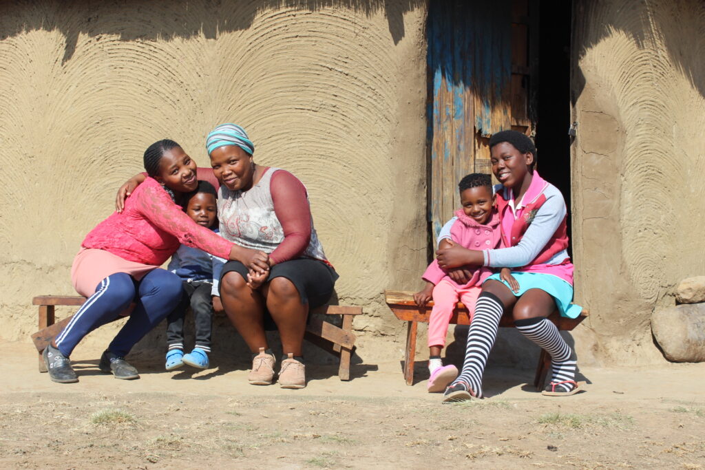 A family in South Africa outside their home