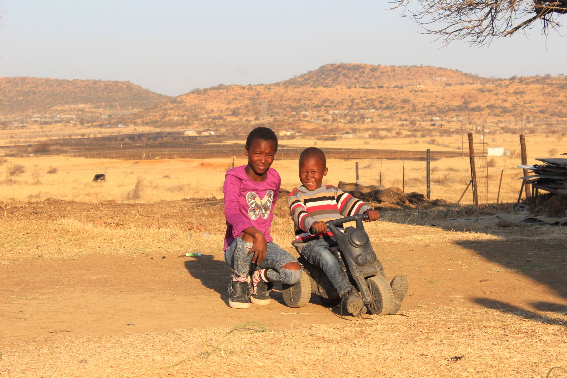 Children, Amahle and Siyanda, playing in the yard
