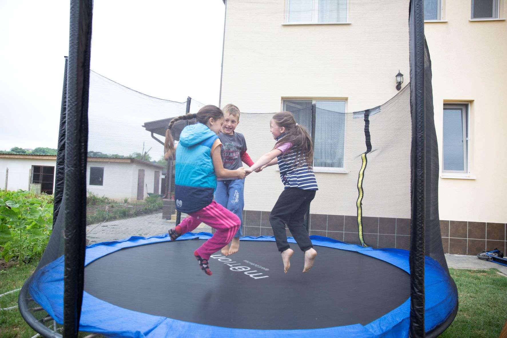 Moraru girls playing with their foster brother.