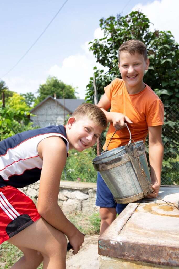 Andrei & Mircea collecting water