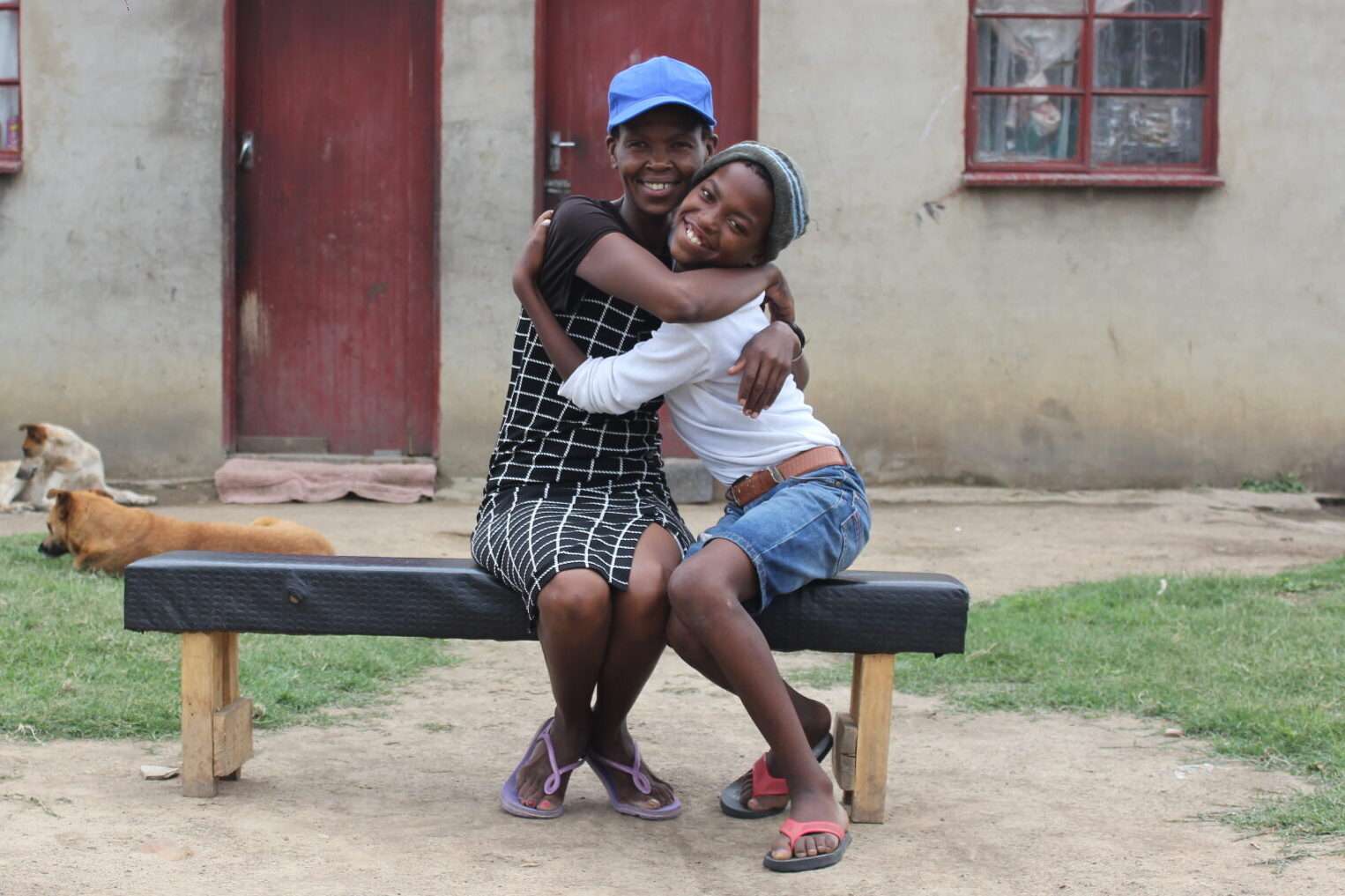 Grace and her son hug outside their home