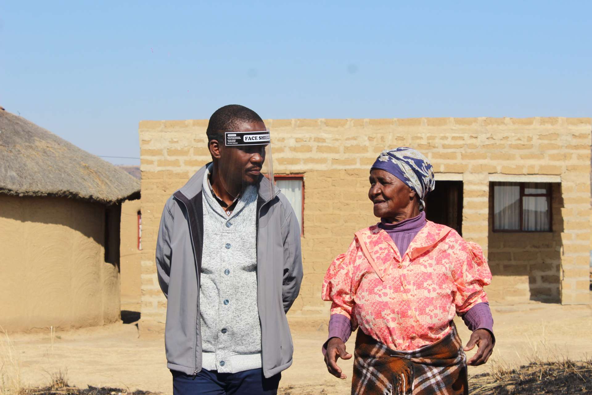 Mhambi outside her home with CERI team member