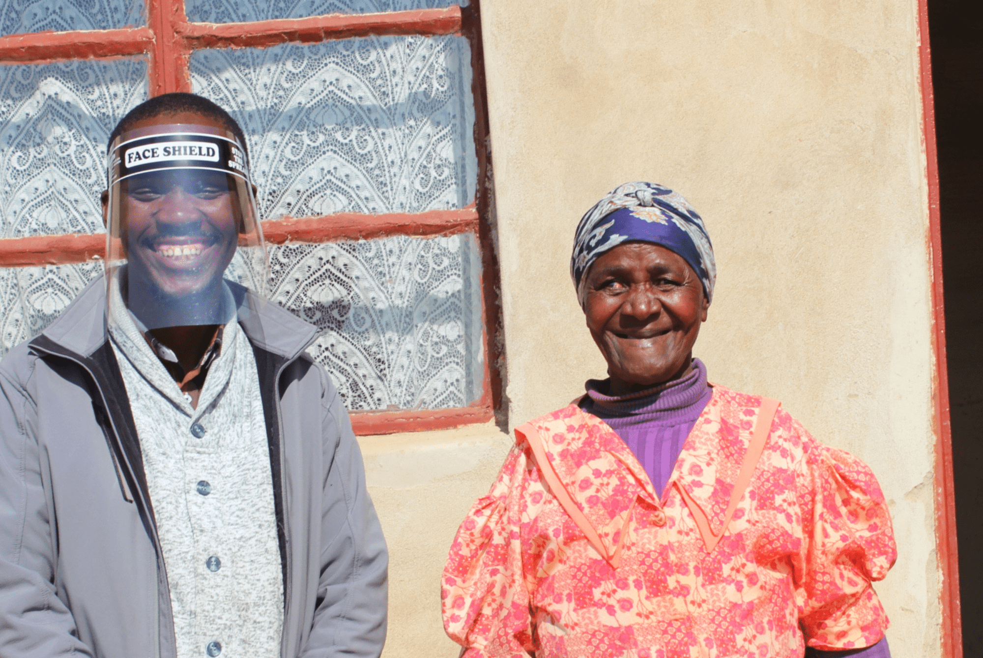 Mhambi outside her home with CERI team member