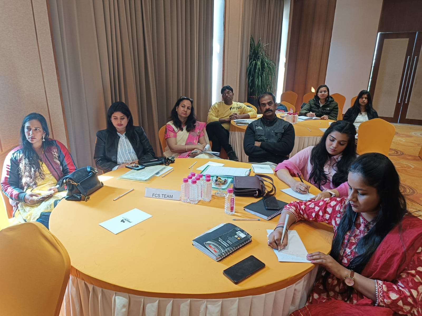 people sit at two tables during a conference